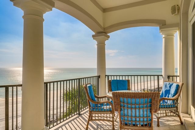Coastal balcony with wicker chairs and ocean view